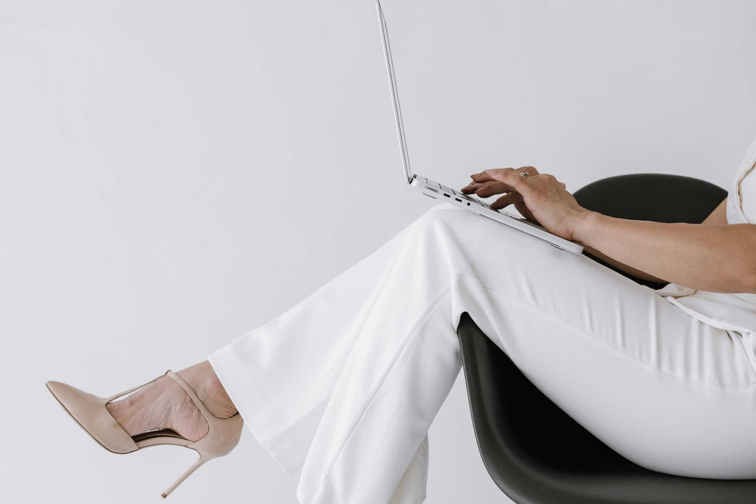 Entrepreneur working on laptop, representing digital planner apps for entrepreneurs and mompreneurs.
