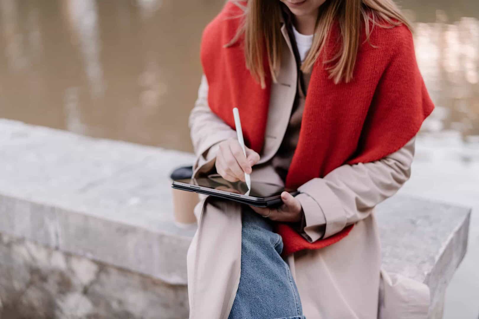 Woman planning on a tablet with stylus, showing flexible digital planner app use.